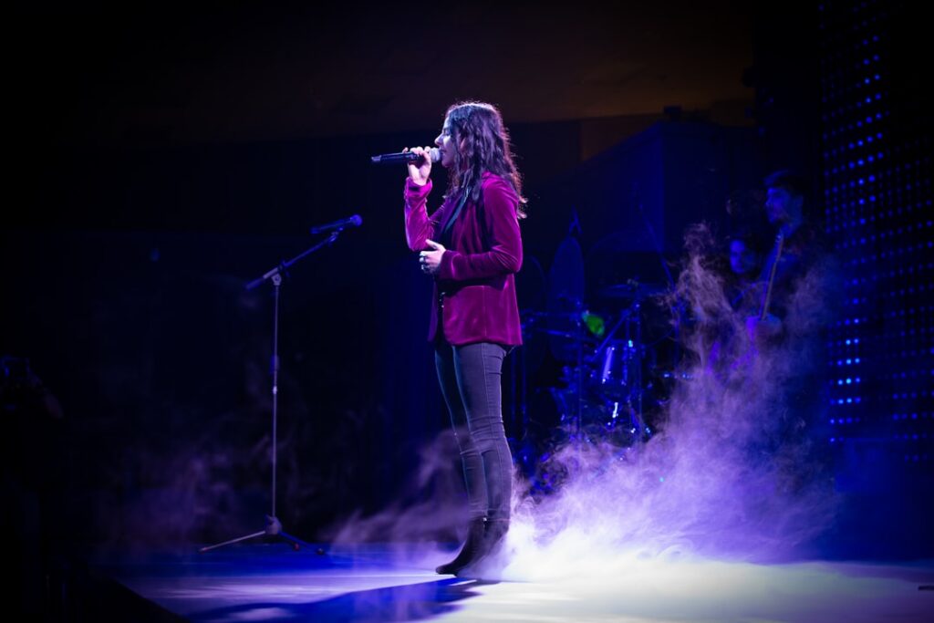 Female singer on stage with fog all around from a fog machine.