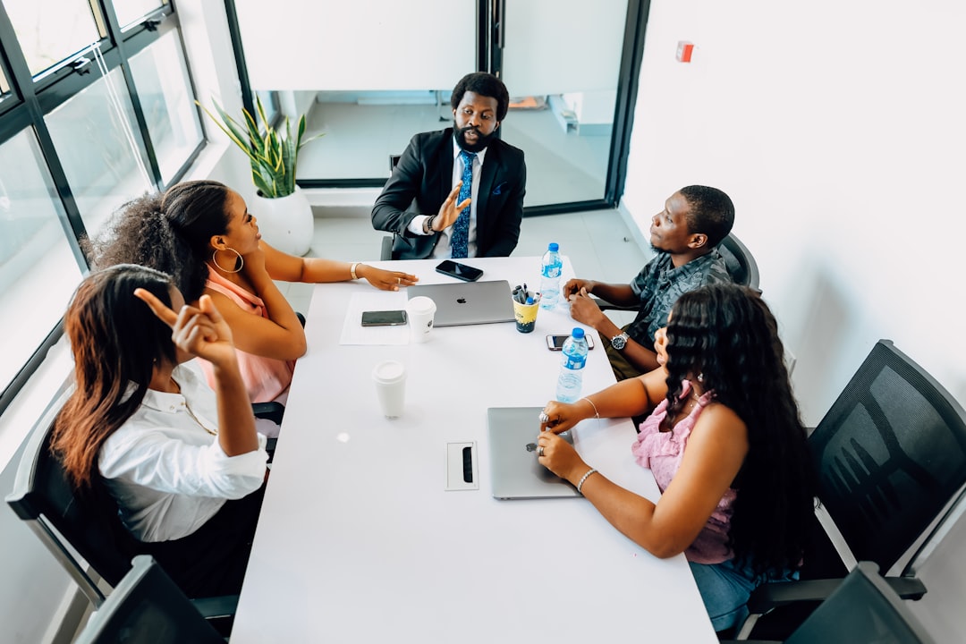 A team and their boss sitting in the conference room and having a meeting. Find more afro-centric images at www.ninthgrid.com