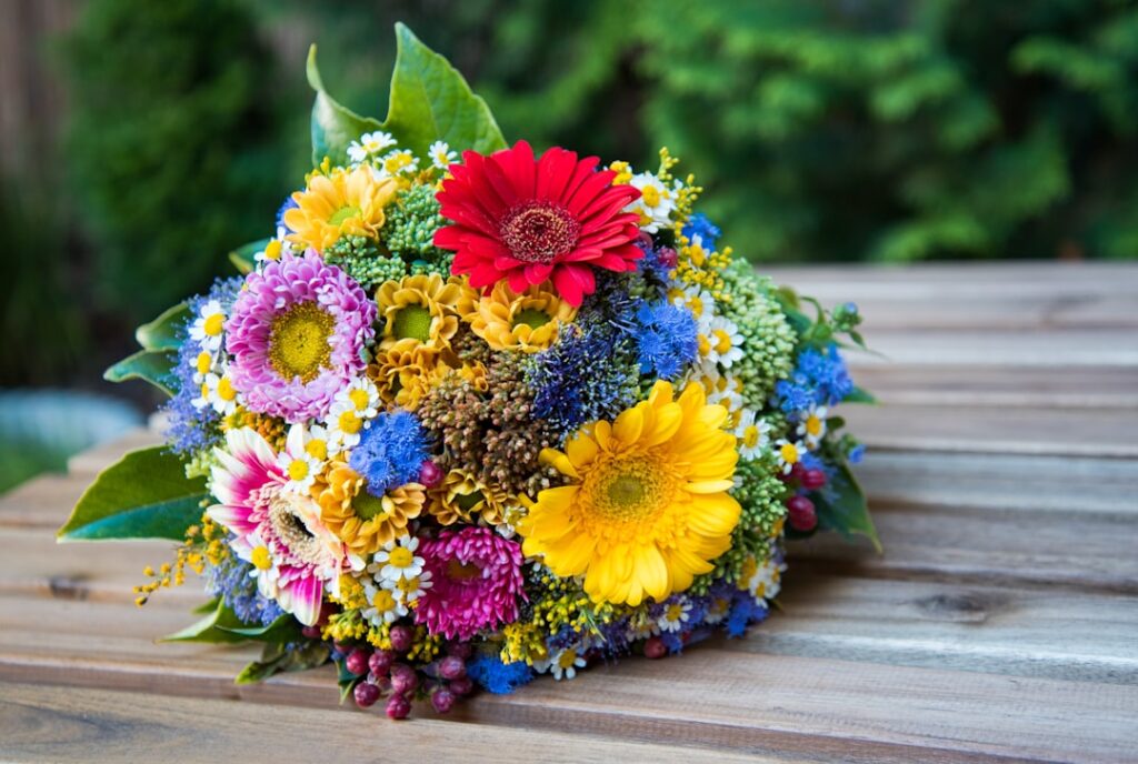 Colorful flower bouquet on the wooden table