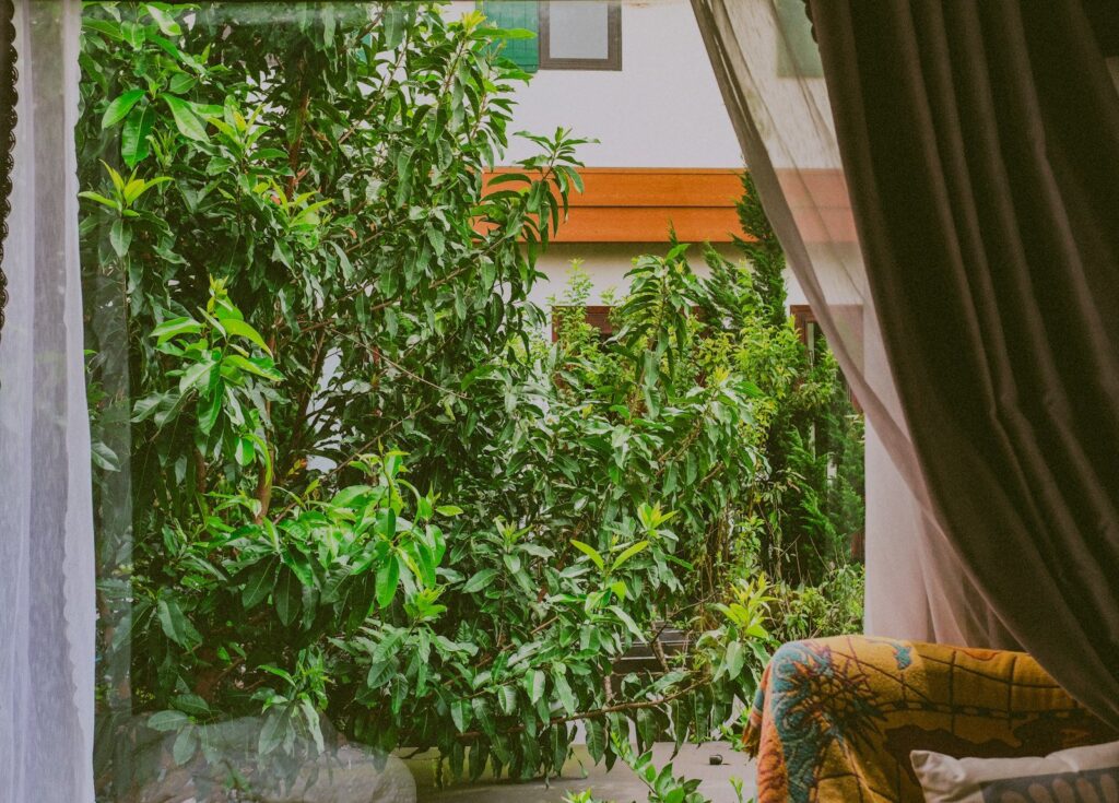 Stoel bij het raam met uitzicht op een groene tuin